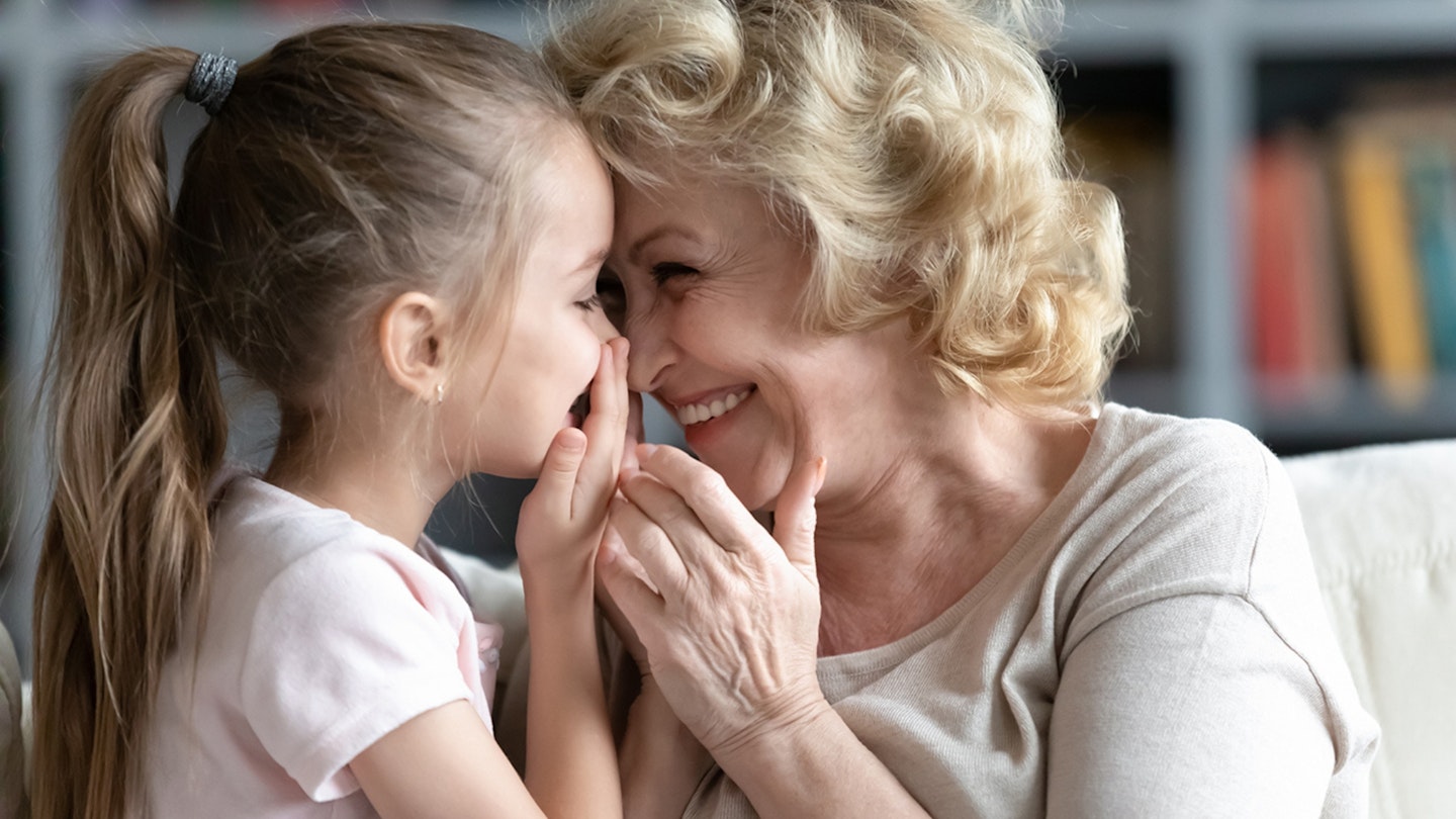 Grandmother and little granddaughter smiling together