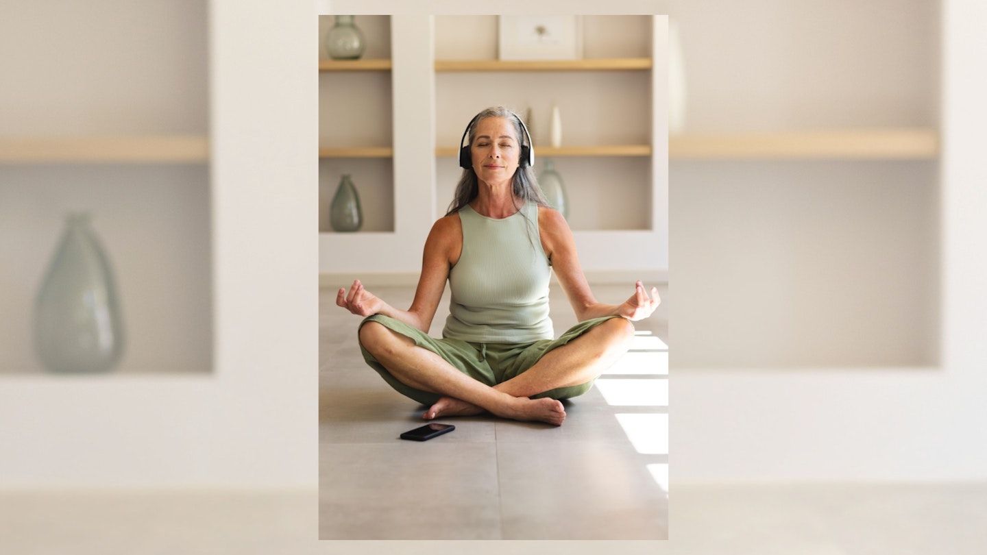 Mature Caucasian woman meditating with headphones