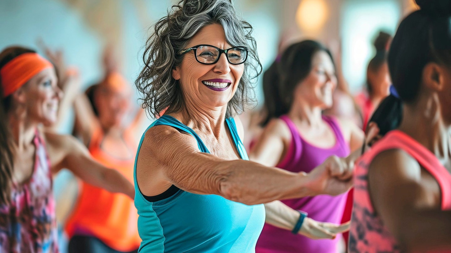 Middle-aged cheerful women having fun at zumba dancing