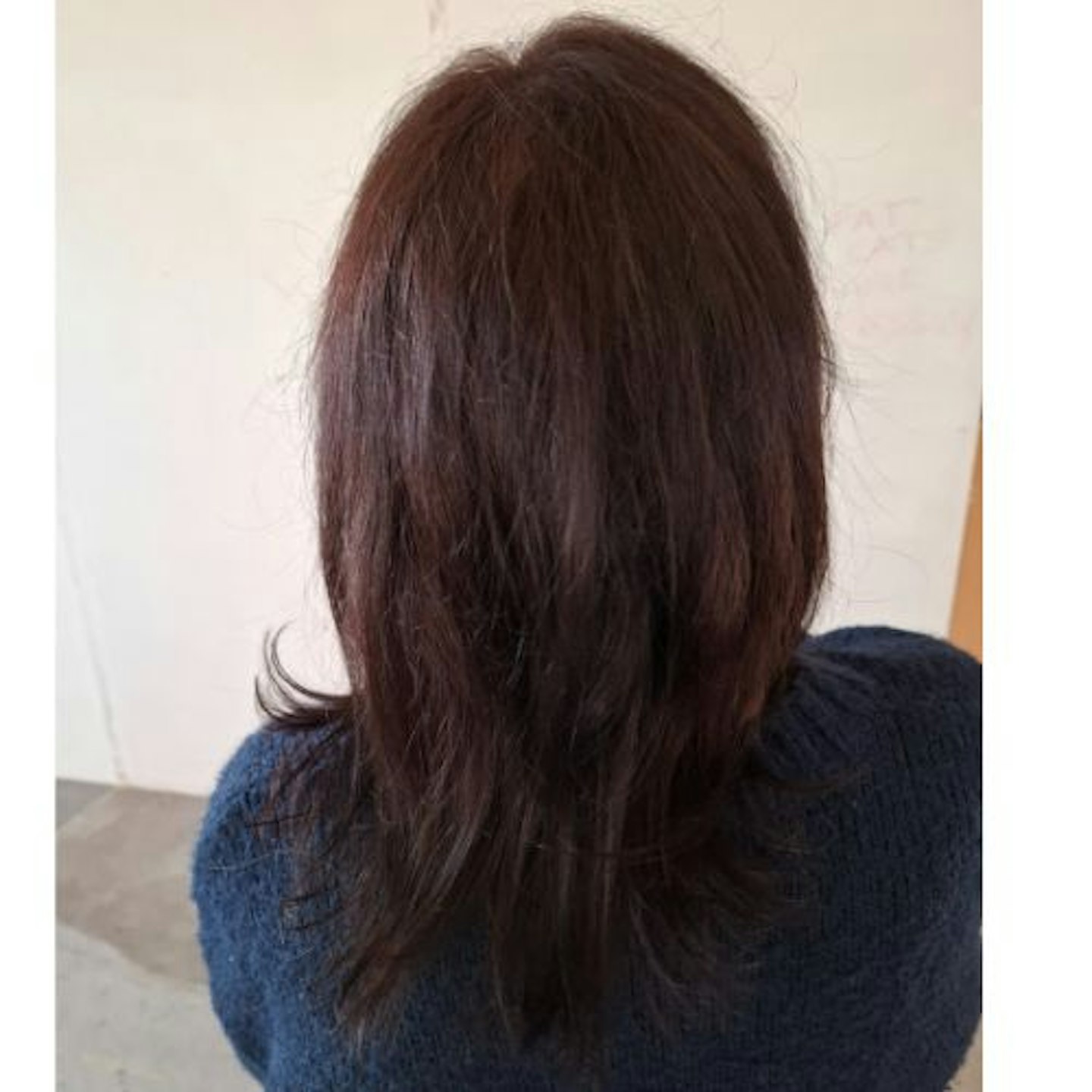 back view of tester's dark brown hair, straightened