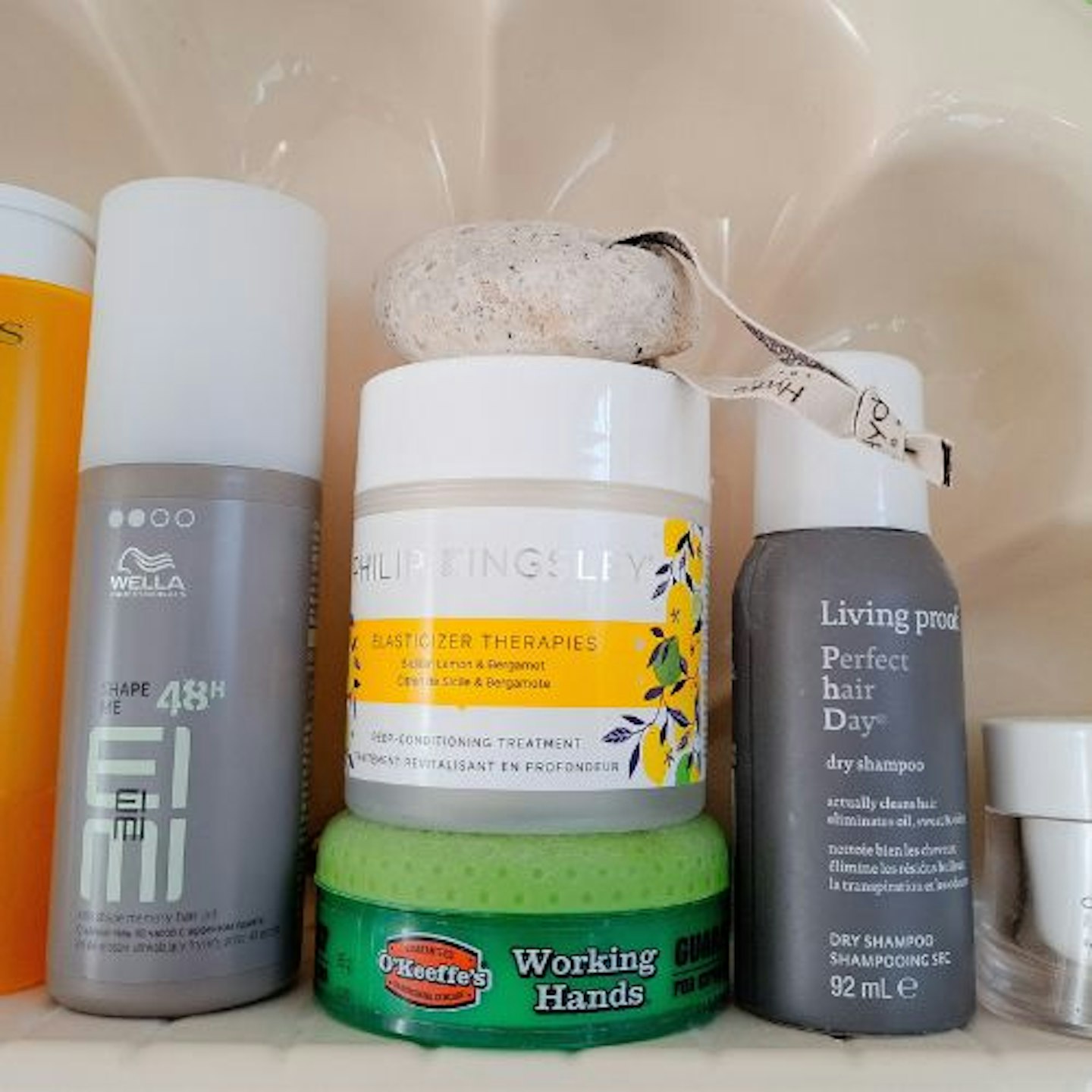 Philip Kingsley’s Elasticizer tub on a shelf with other haircare products