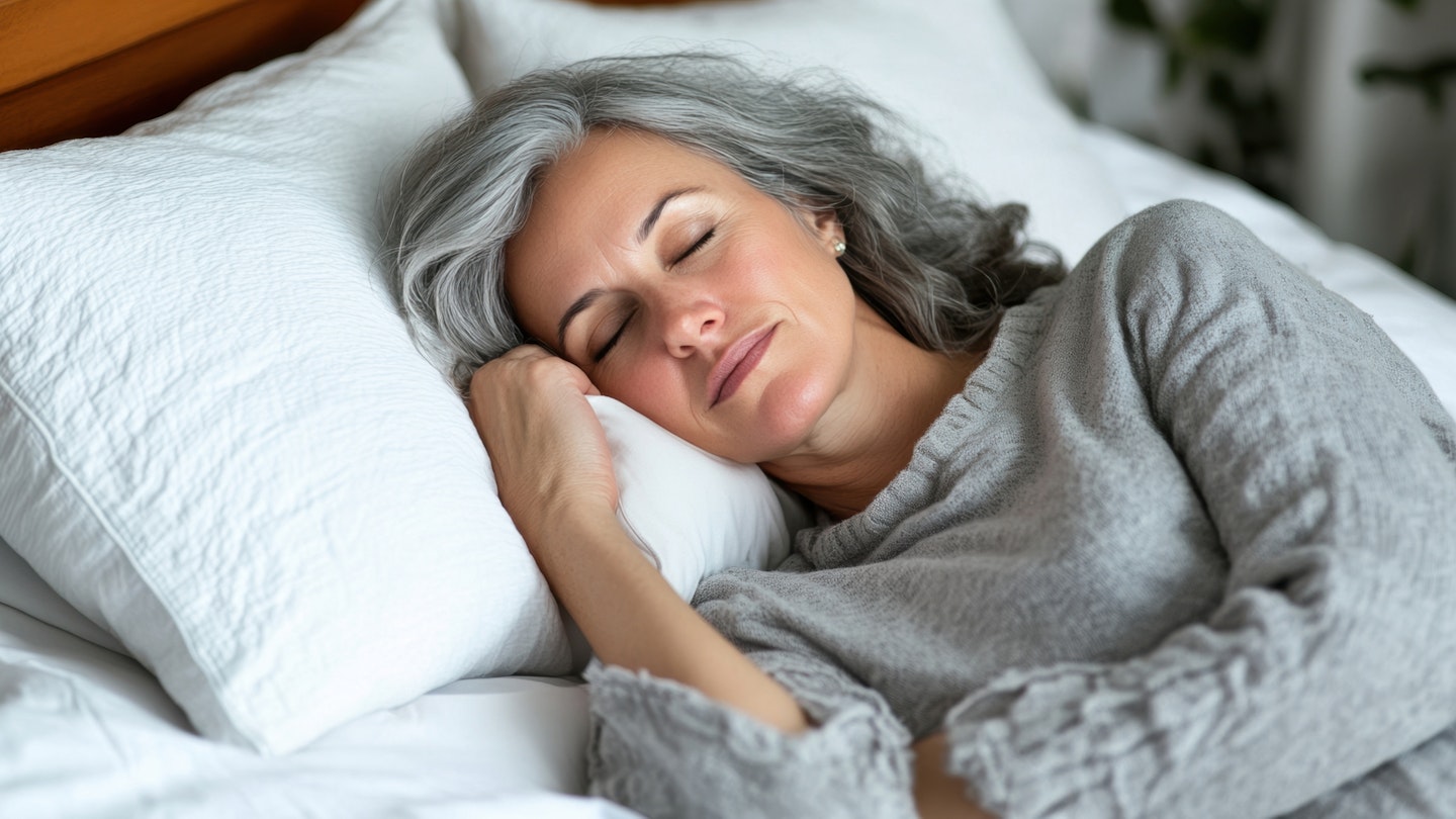 Tranquil middle-aged woman sleeping peacefully in bed