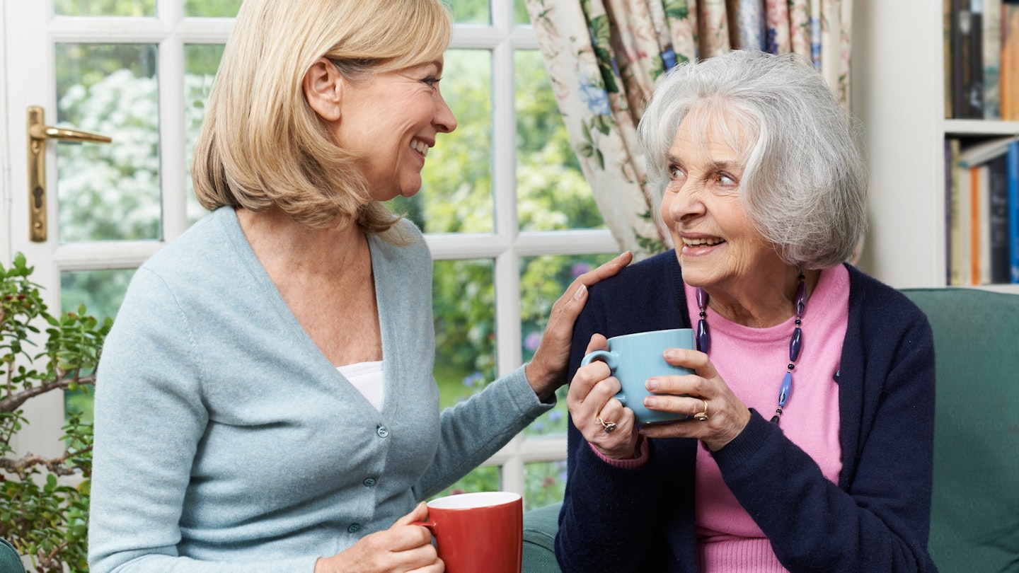 Woman Taking Time To Visit Senior Female Neighbor