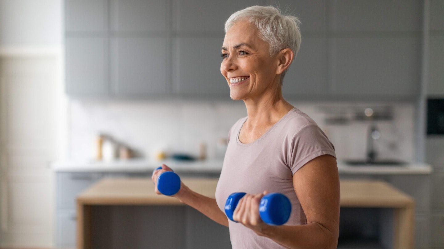 Woman using dumbbells at home