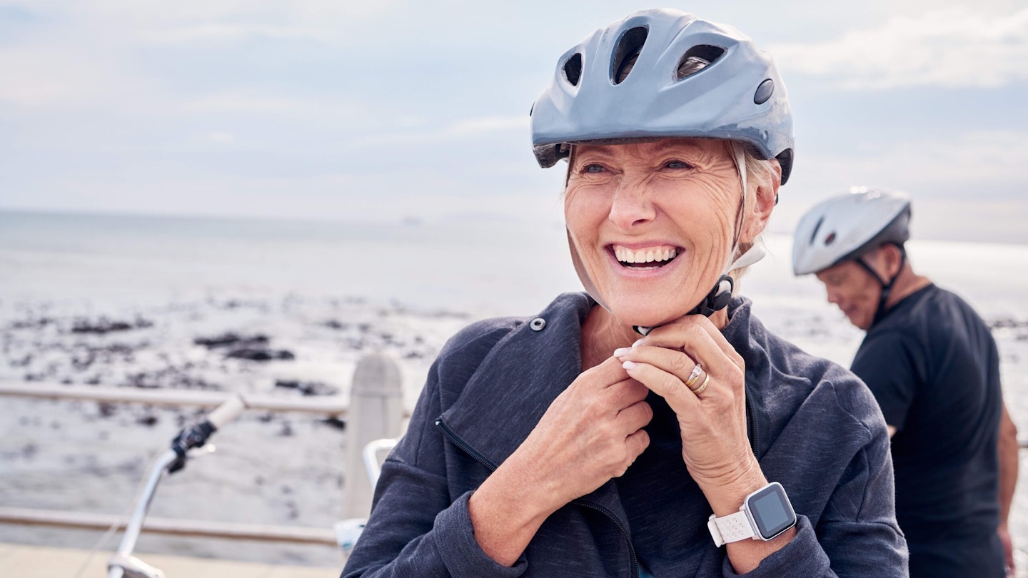 Woman fastening her bike helmet