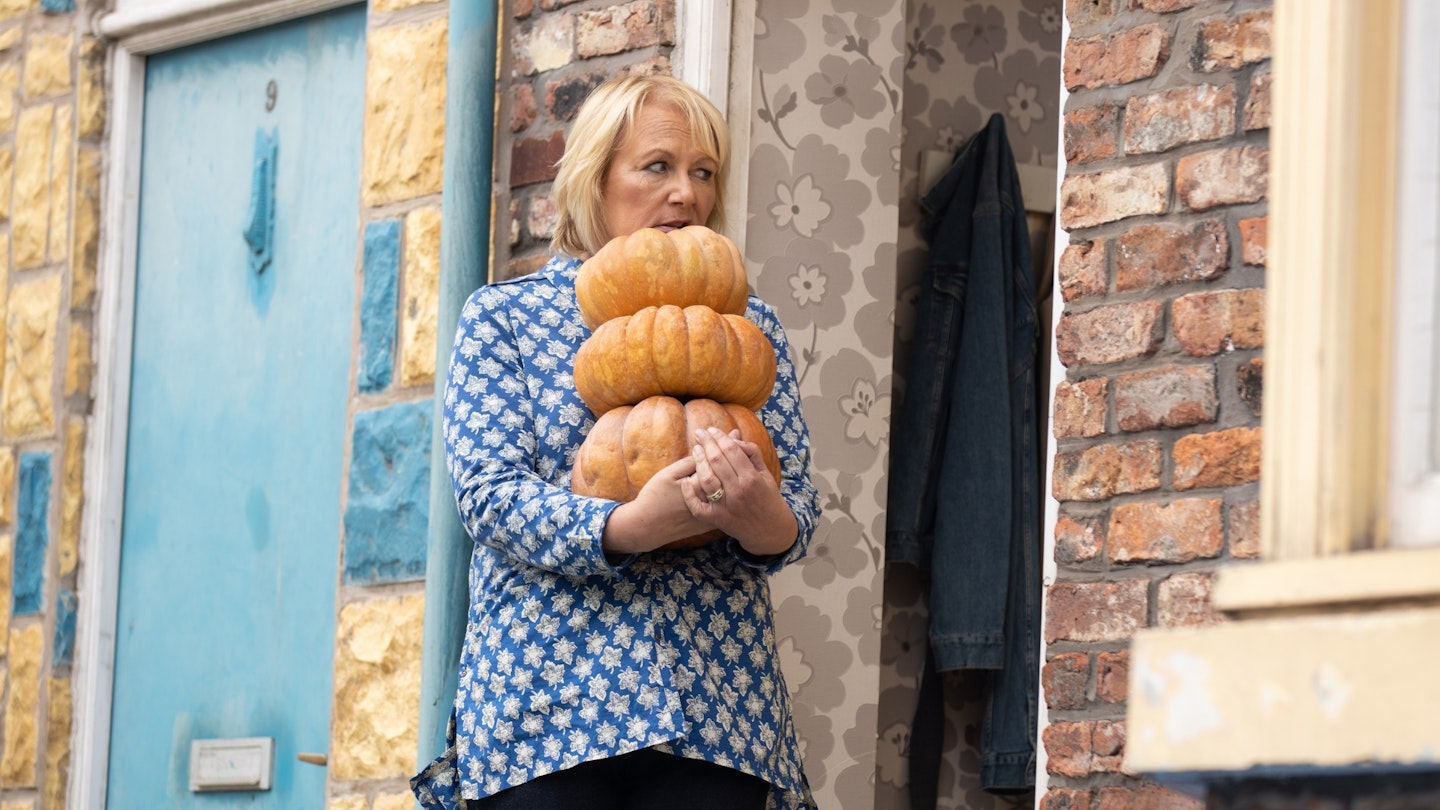 Eileen Grimshaw, as played by Sue Cleaver, picks up Glenda's pumpkin and heads out with it