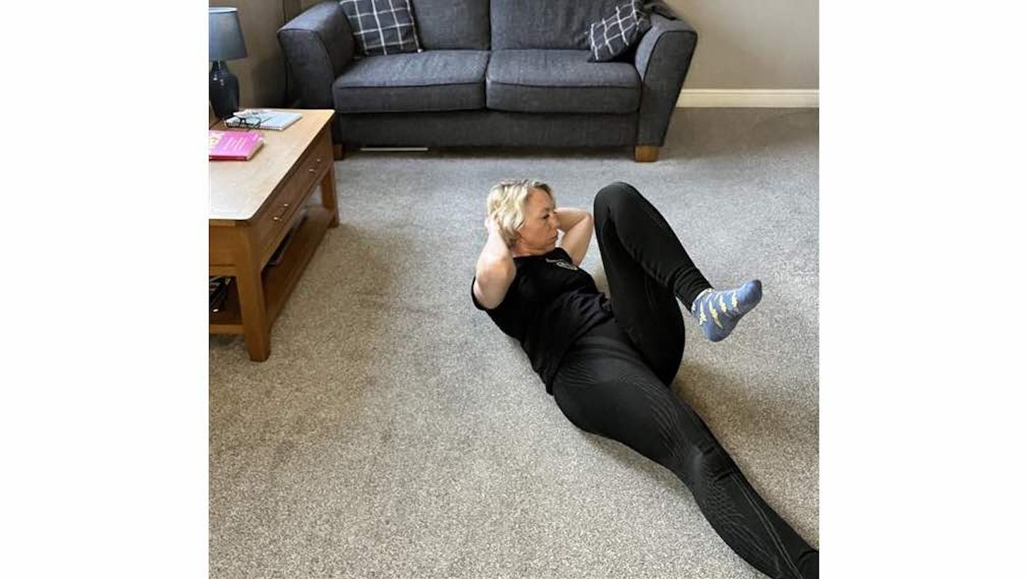 Woman doing a bicycle exercise on her back