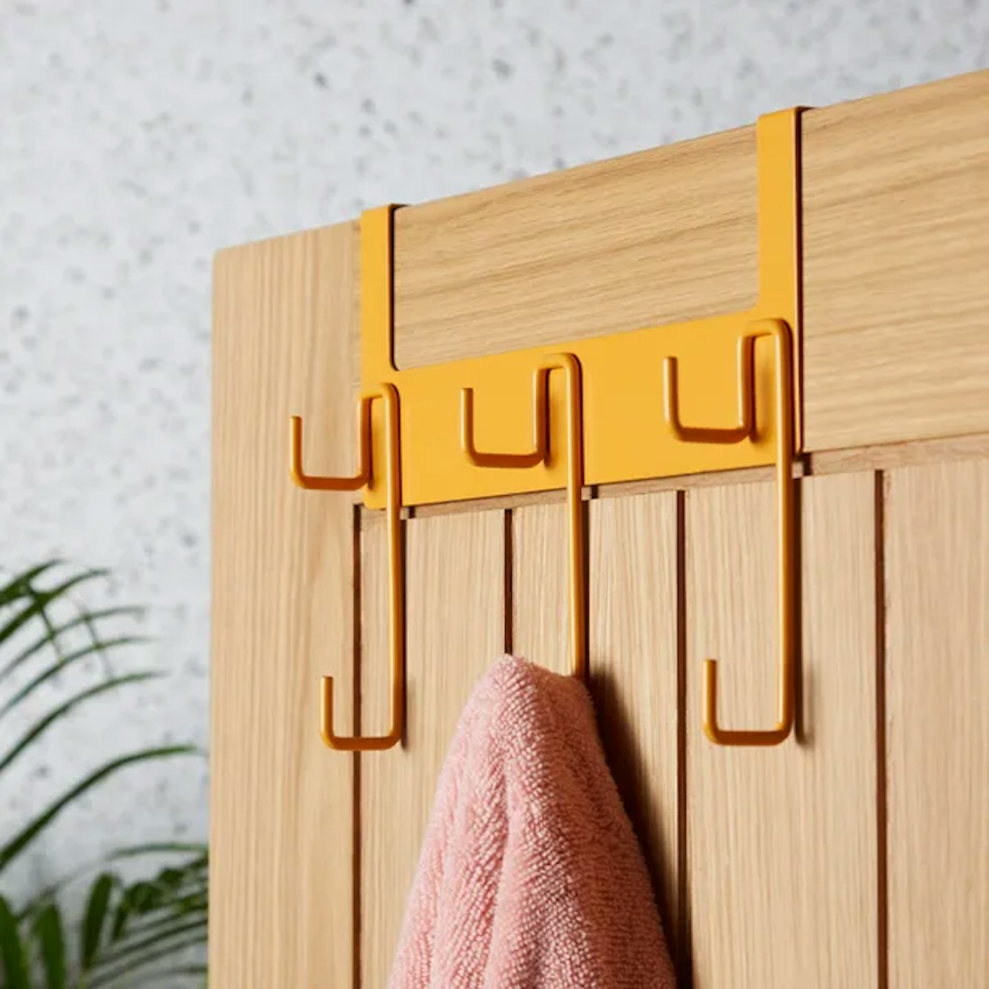 Image of the Elements Overdoor Hooks with a towel hanging on it 