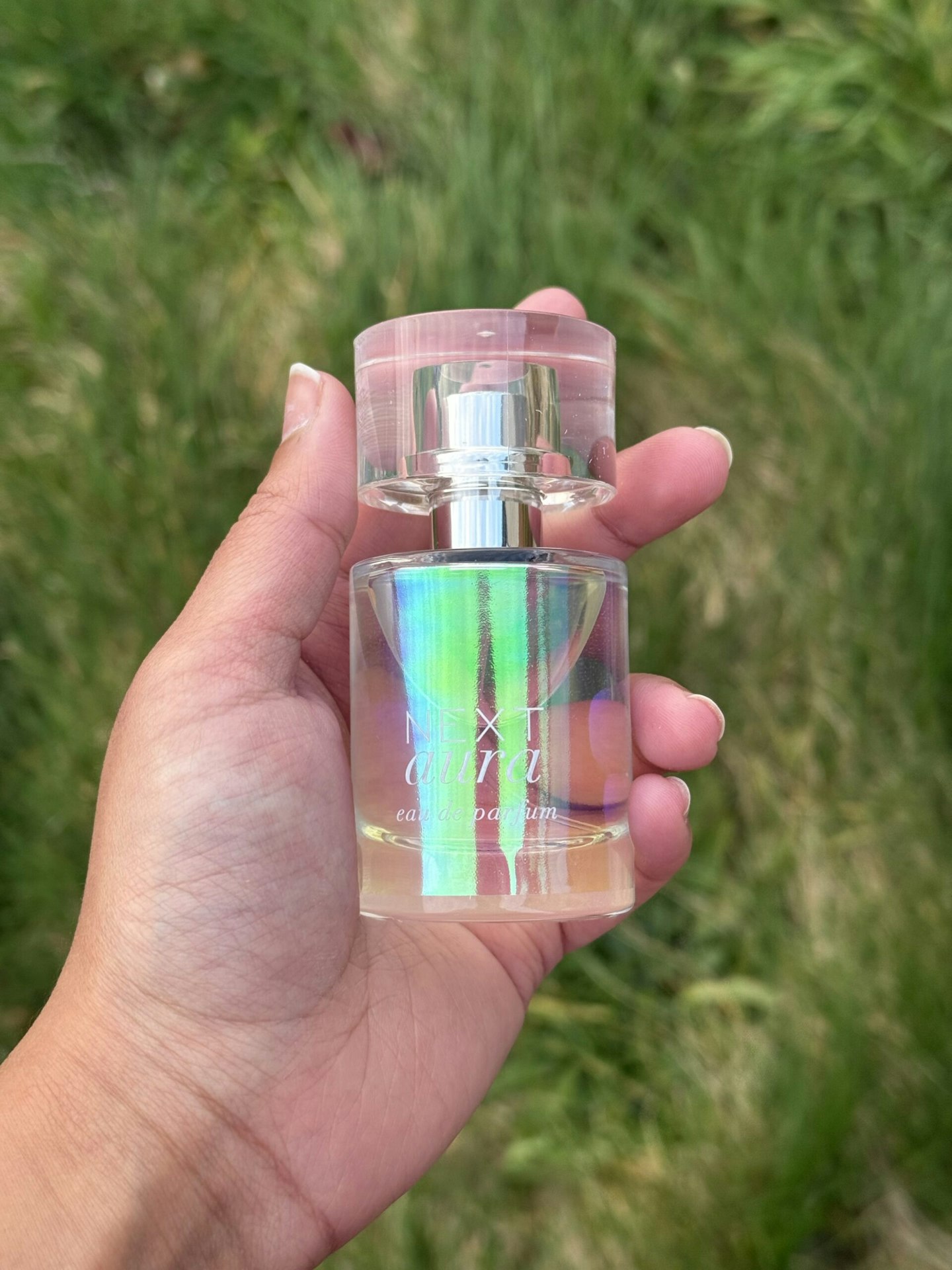 Tester holding the Aura Perfume