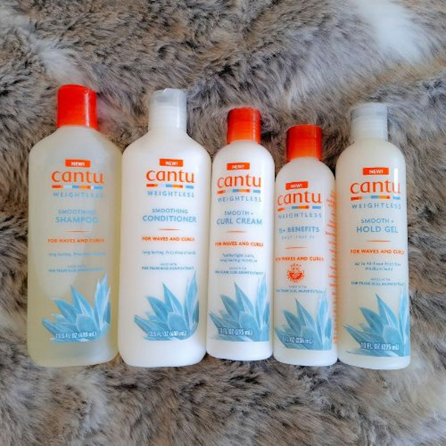 photo of the entire range of Cantu Weightless Smoothing hair care products on faux fur background