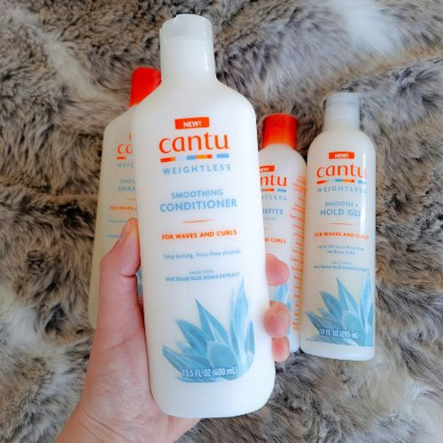 Cantu Weightless Smoothing Conditioner in tester's hand