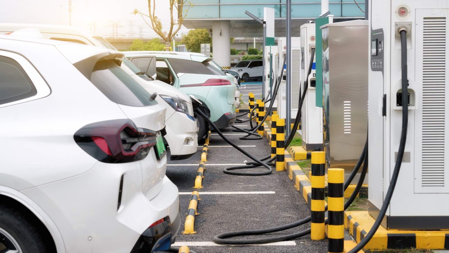 A line of EV cars at charging points