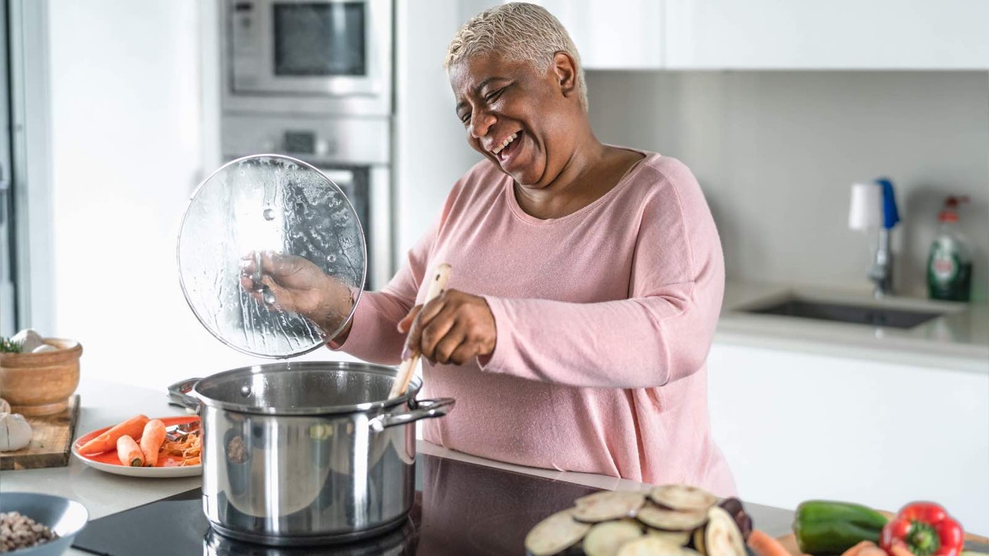 Woman cooking in the kitchen with a large pot