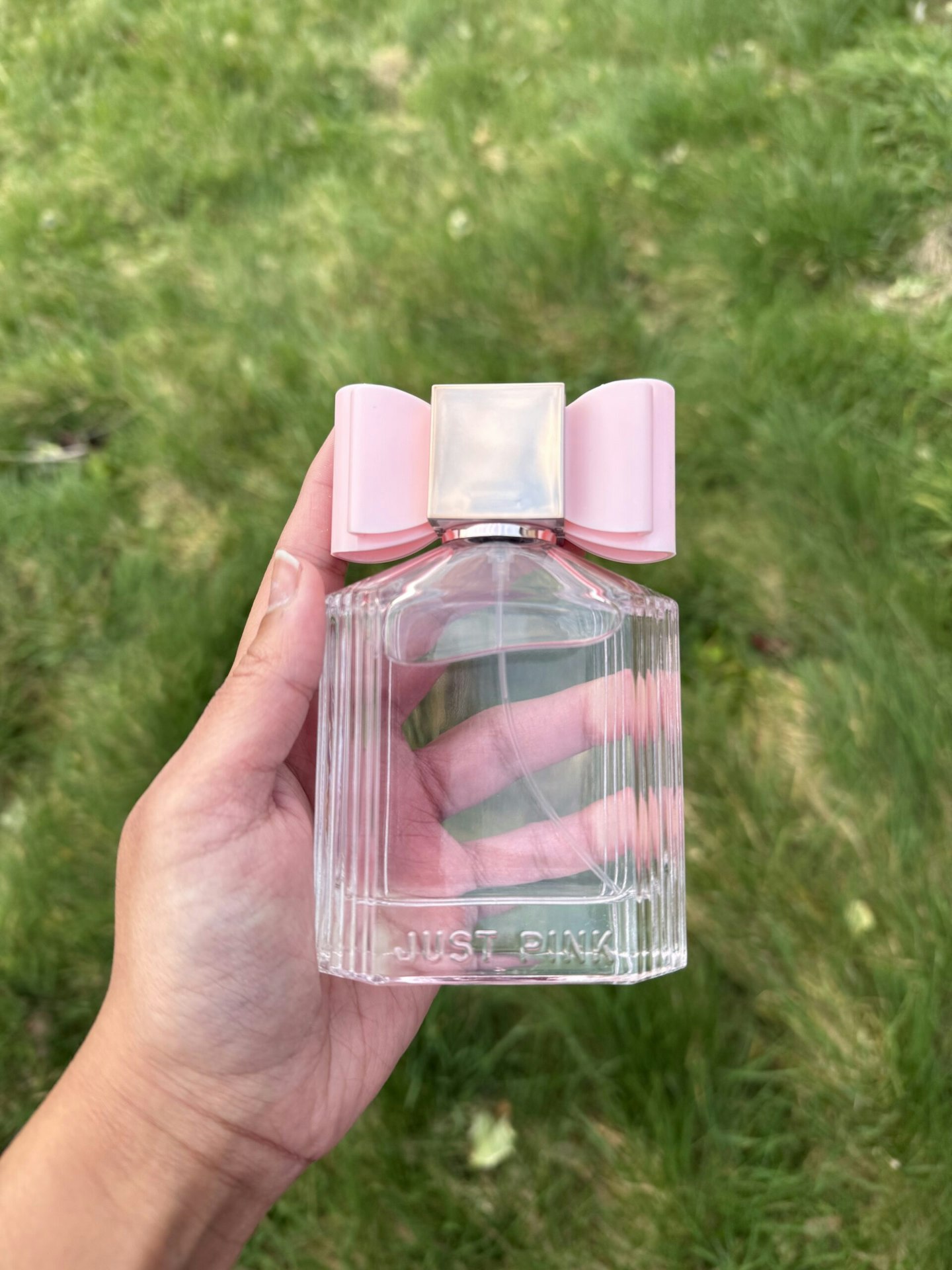 Tester holding the Just Pink Perfume