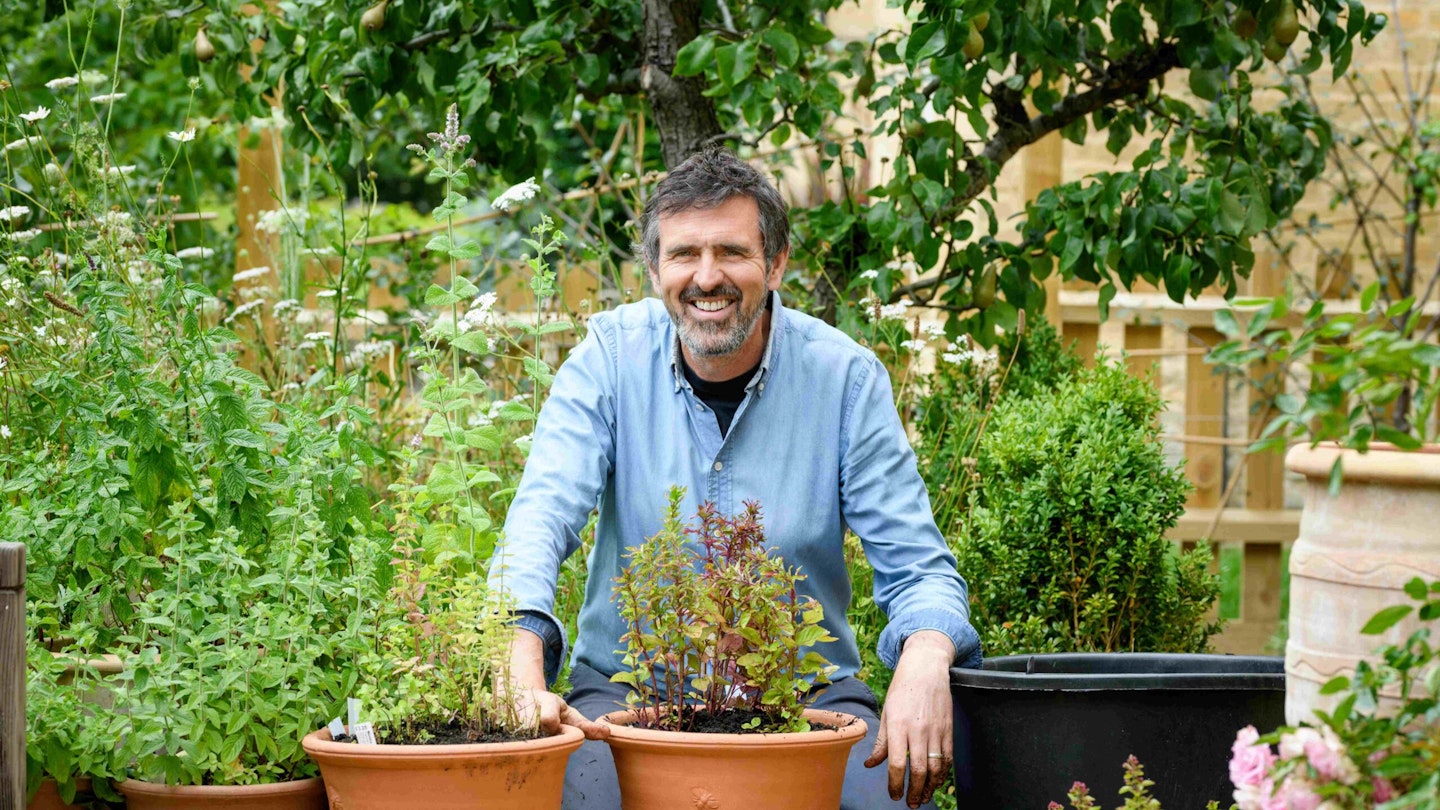 Adam Frost in garden with plant pots