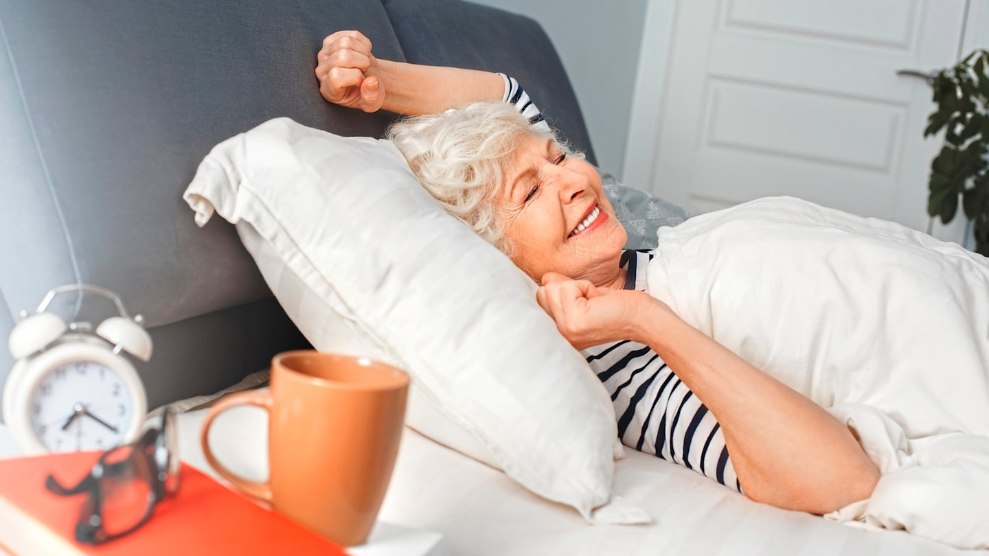 Woman stretching while laying in bed