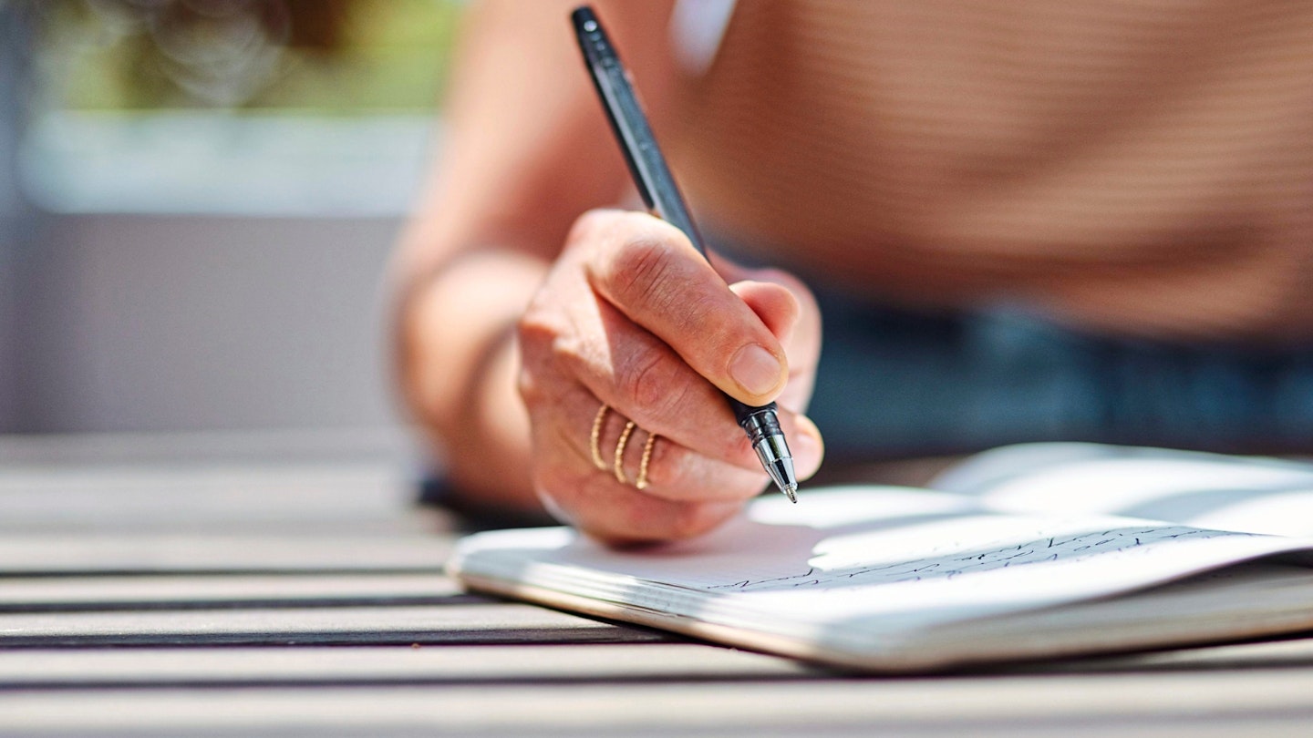 Woman writing in a notebook