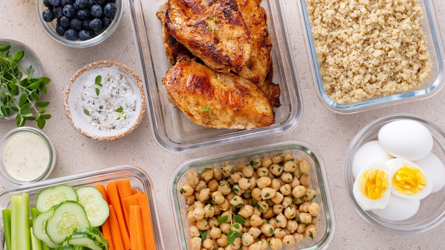 Quinoa, eggs, chick peas, chicken and cucumber in glass dishes