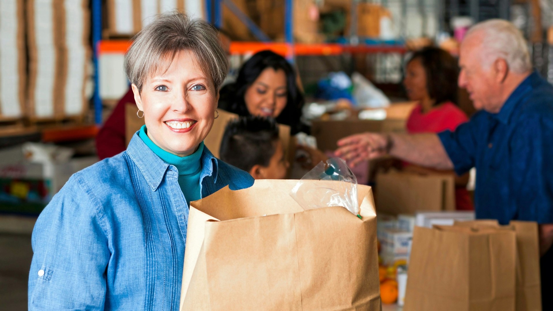 Woman holding brown paper shopping bag
