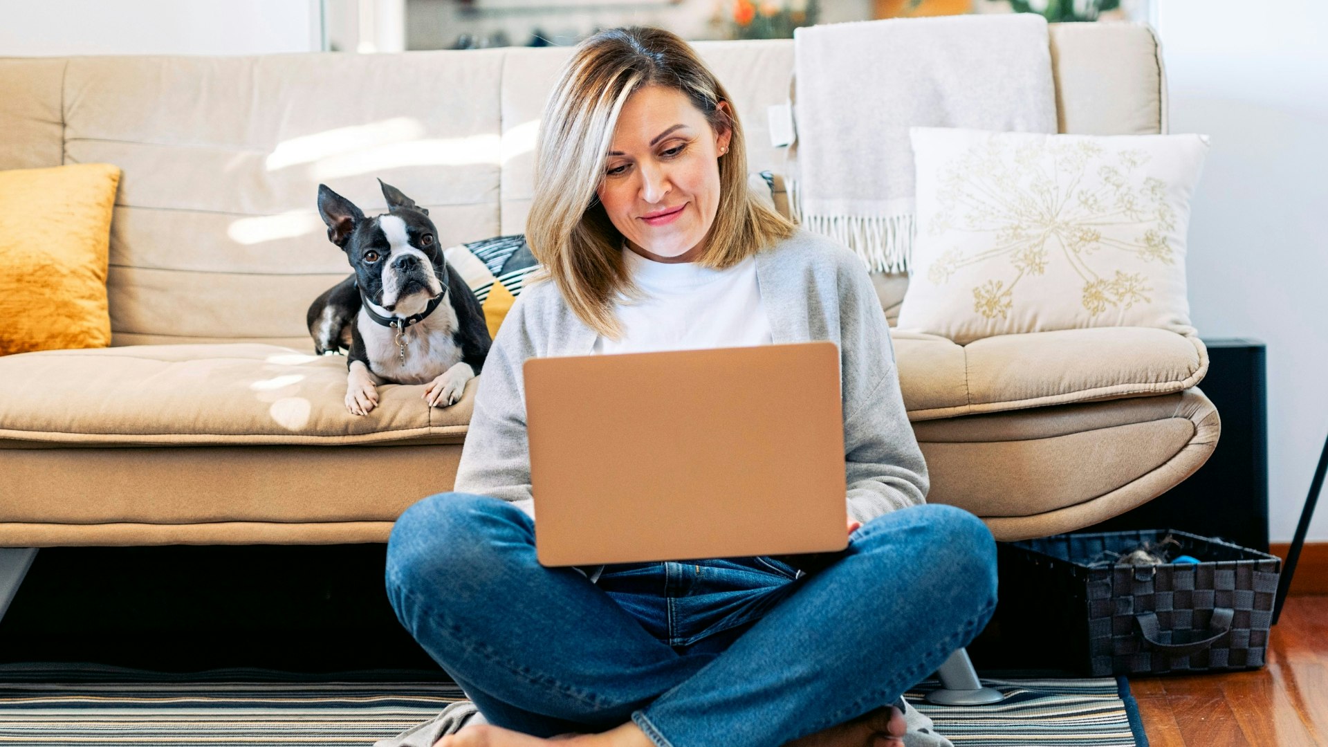 Woman on laptop sitting on the floor