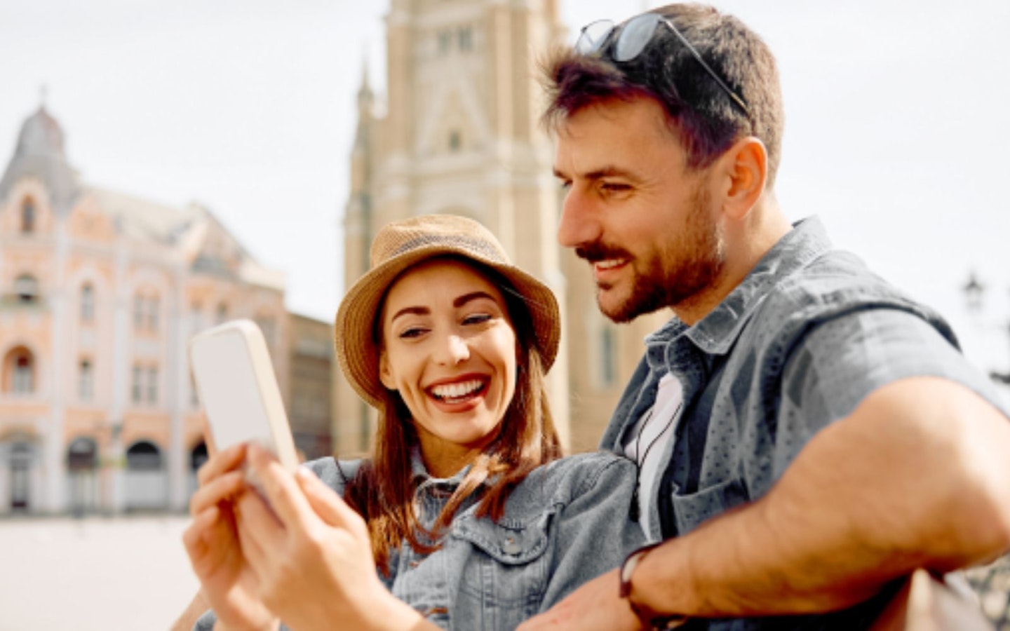 A couple using a smartphone on holiday