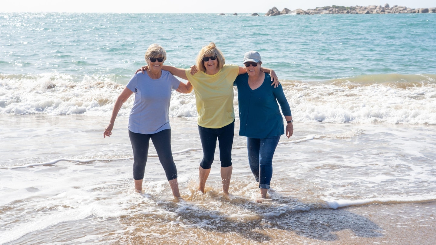 Three women walking on the beach