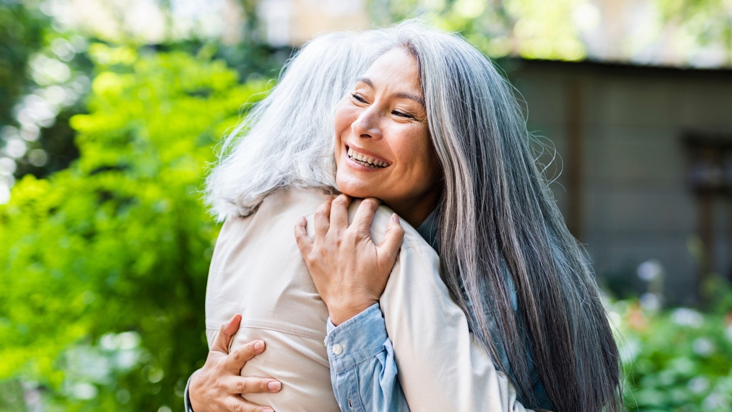 Two women hugging each other