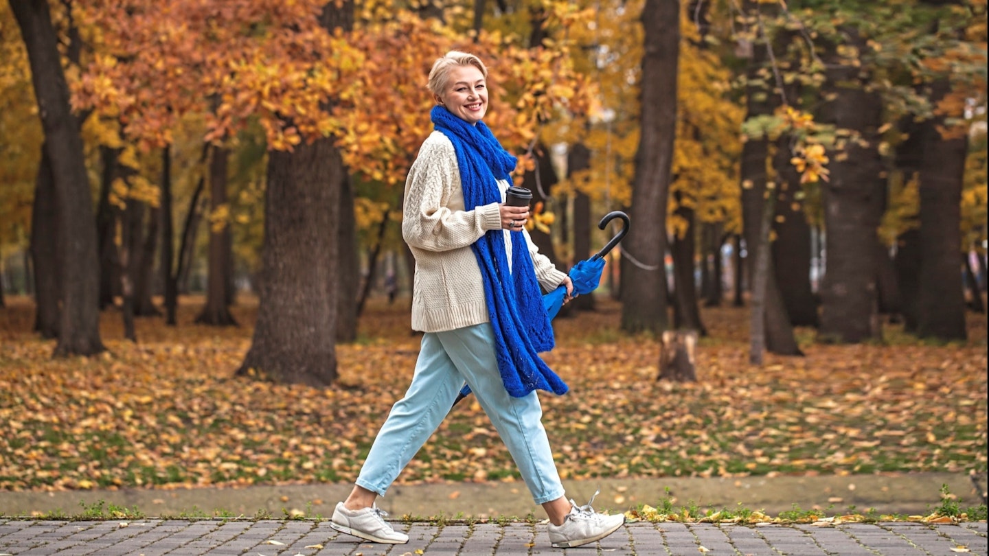 Smiling lady walking in the park