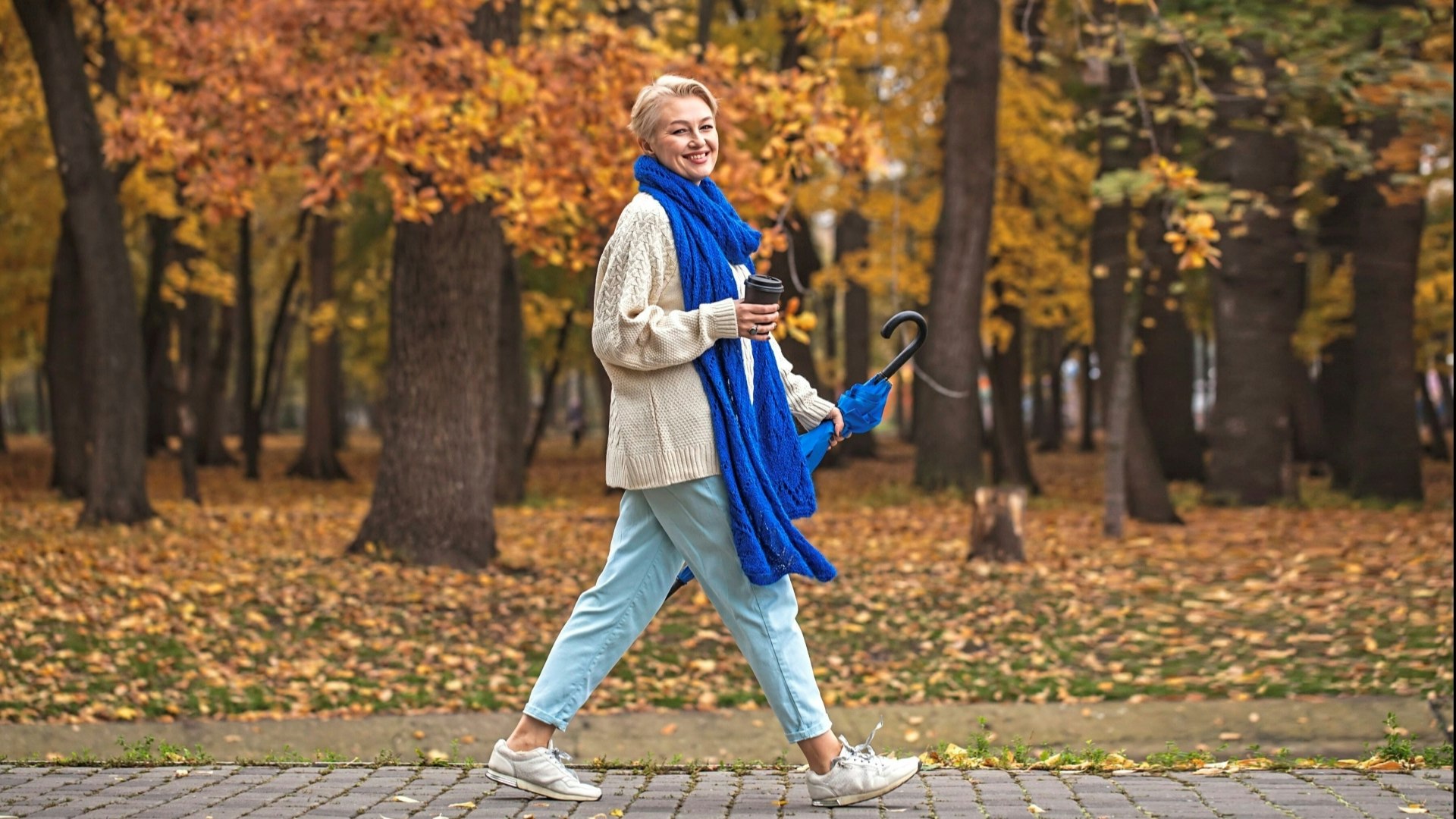 Smiling lady walking in the park