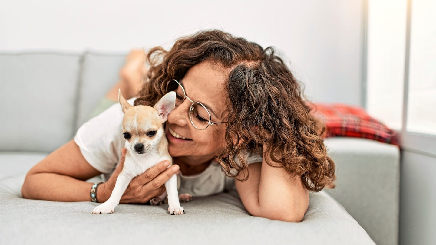 Smiling lady hugging her dog