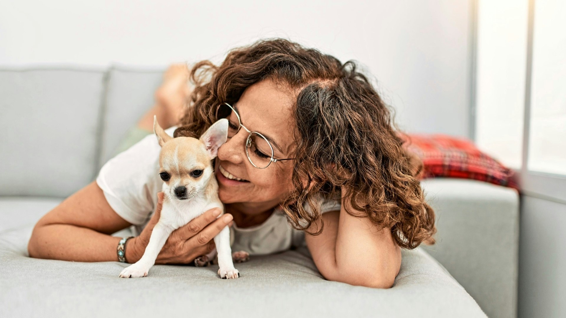 Smiling lady hugging her dog