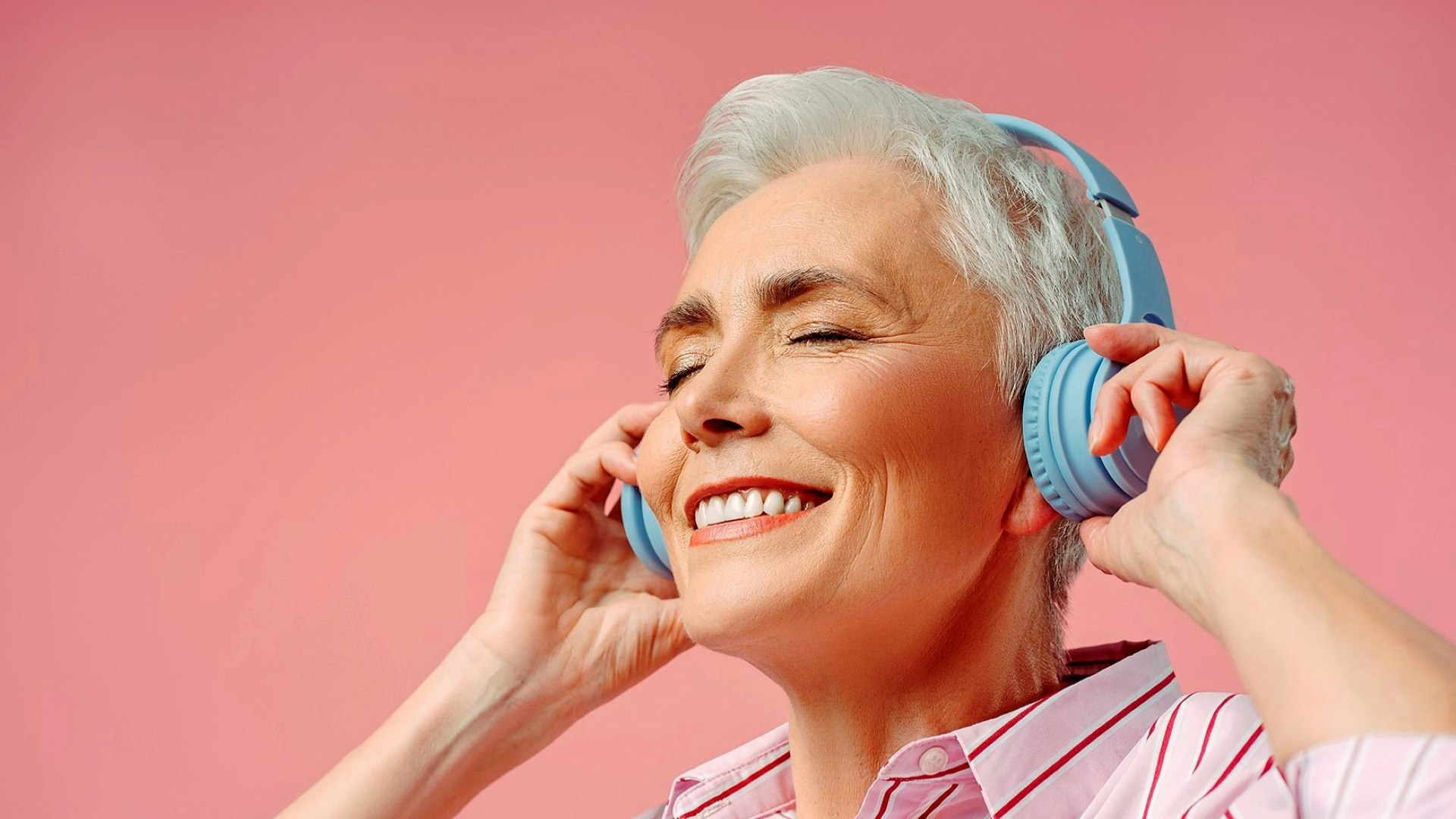 Smiling lady listening to music with headphone