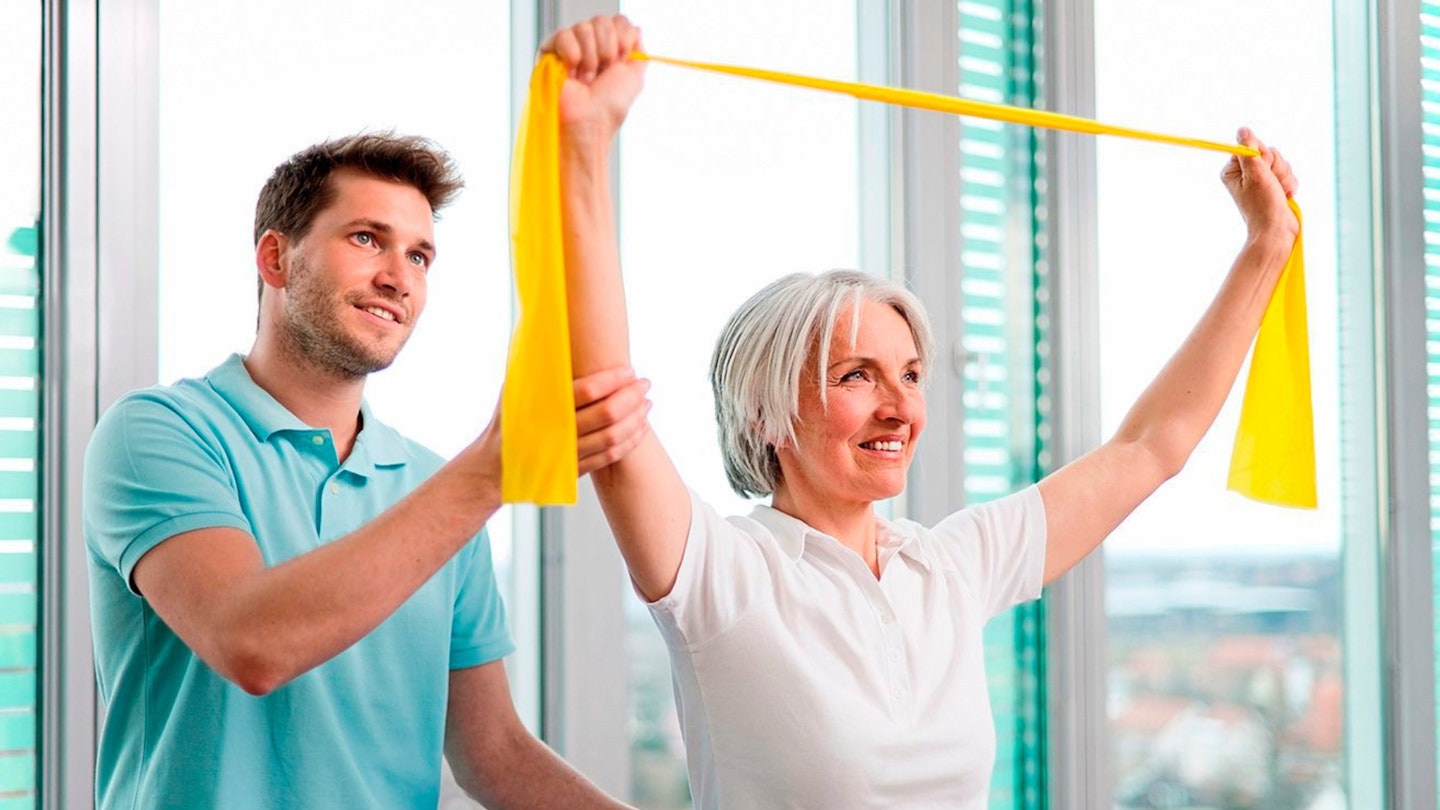 Trainer working with woman in gym
