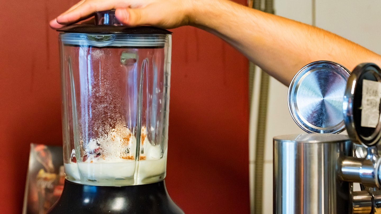 Blender with of ice cream close, preparing smoothie