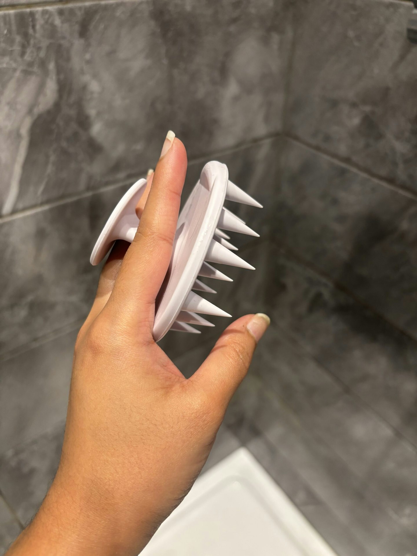 tester holding the Boots Scalp Massage Brush