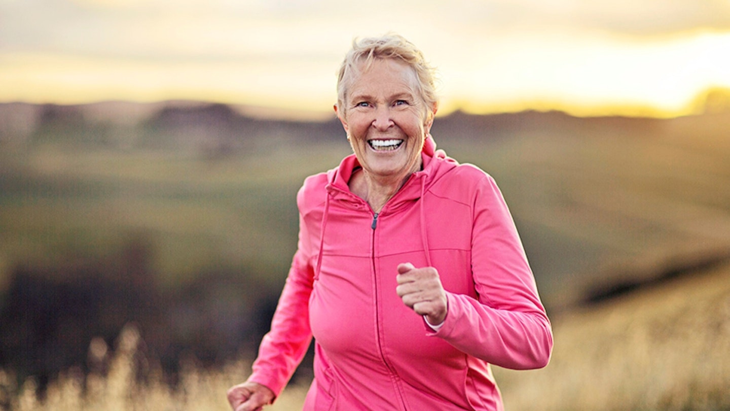 Happy active senior woman running