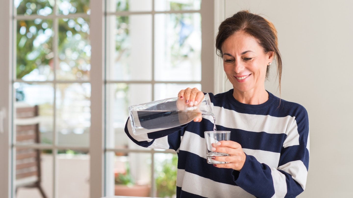 Woman pouring a glass of water