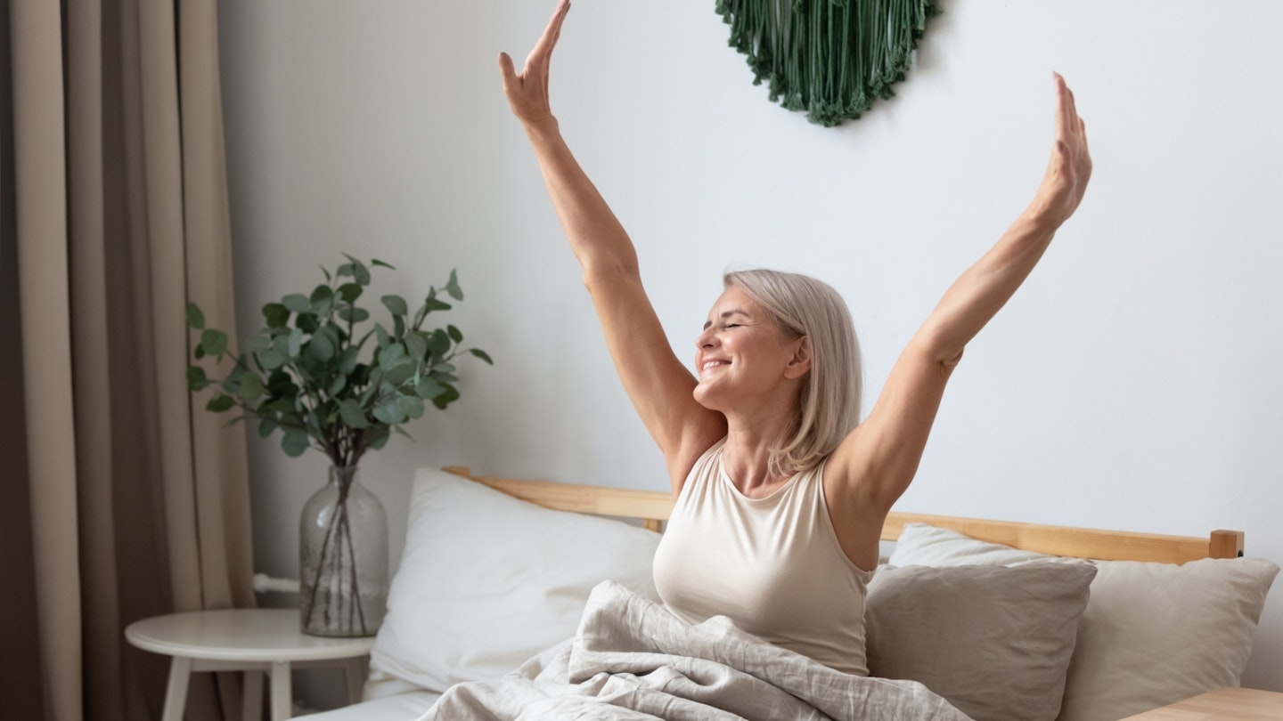 Woman waking up from sleep stretching