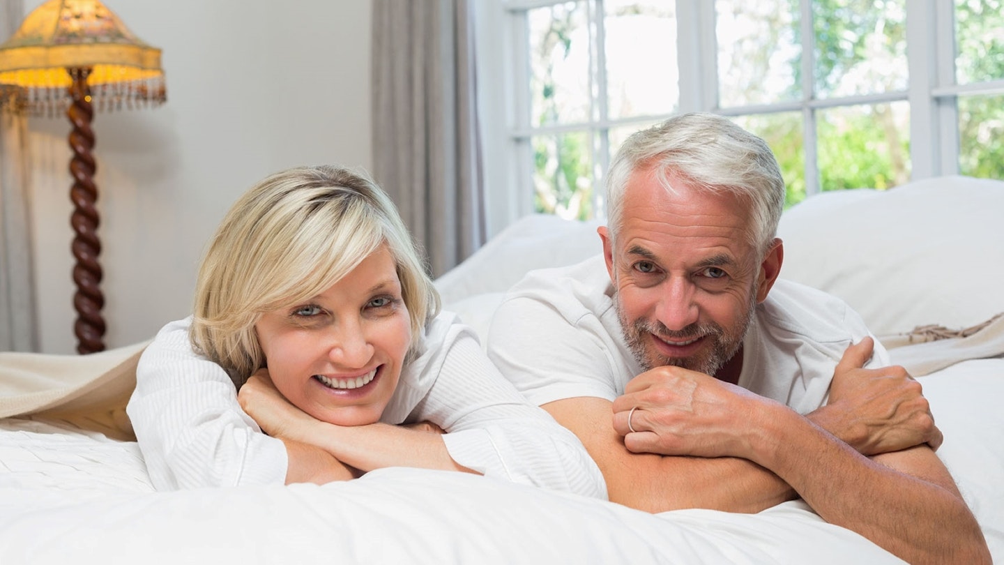 Happy couple laying in bed