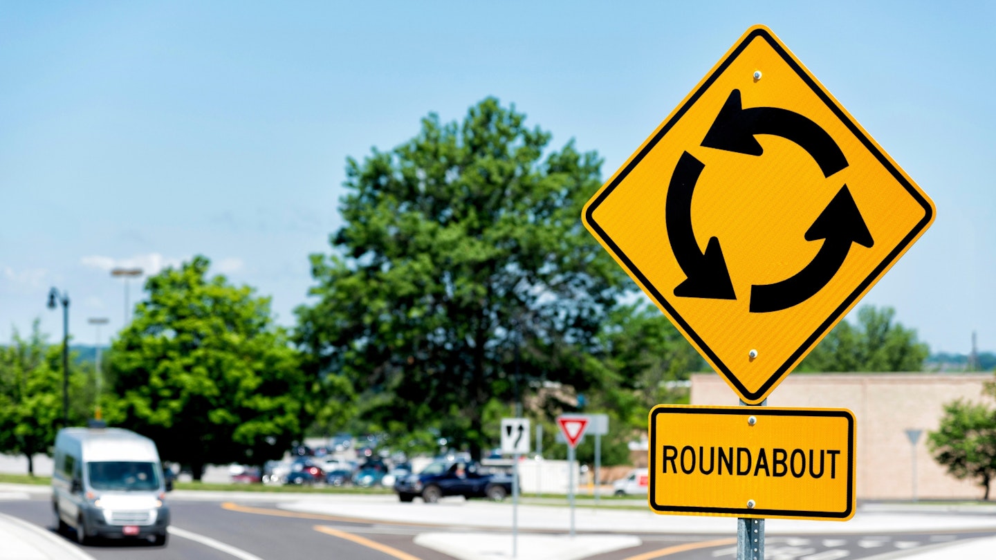 Roundabout sign showing roundabout intersection