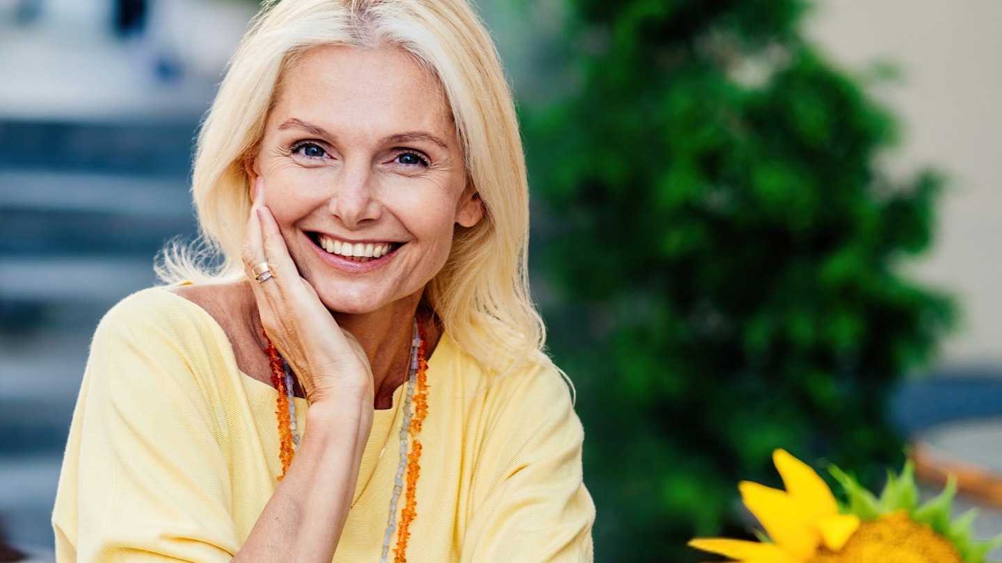 happy senior adult woman sitting