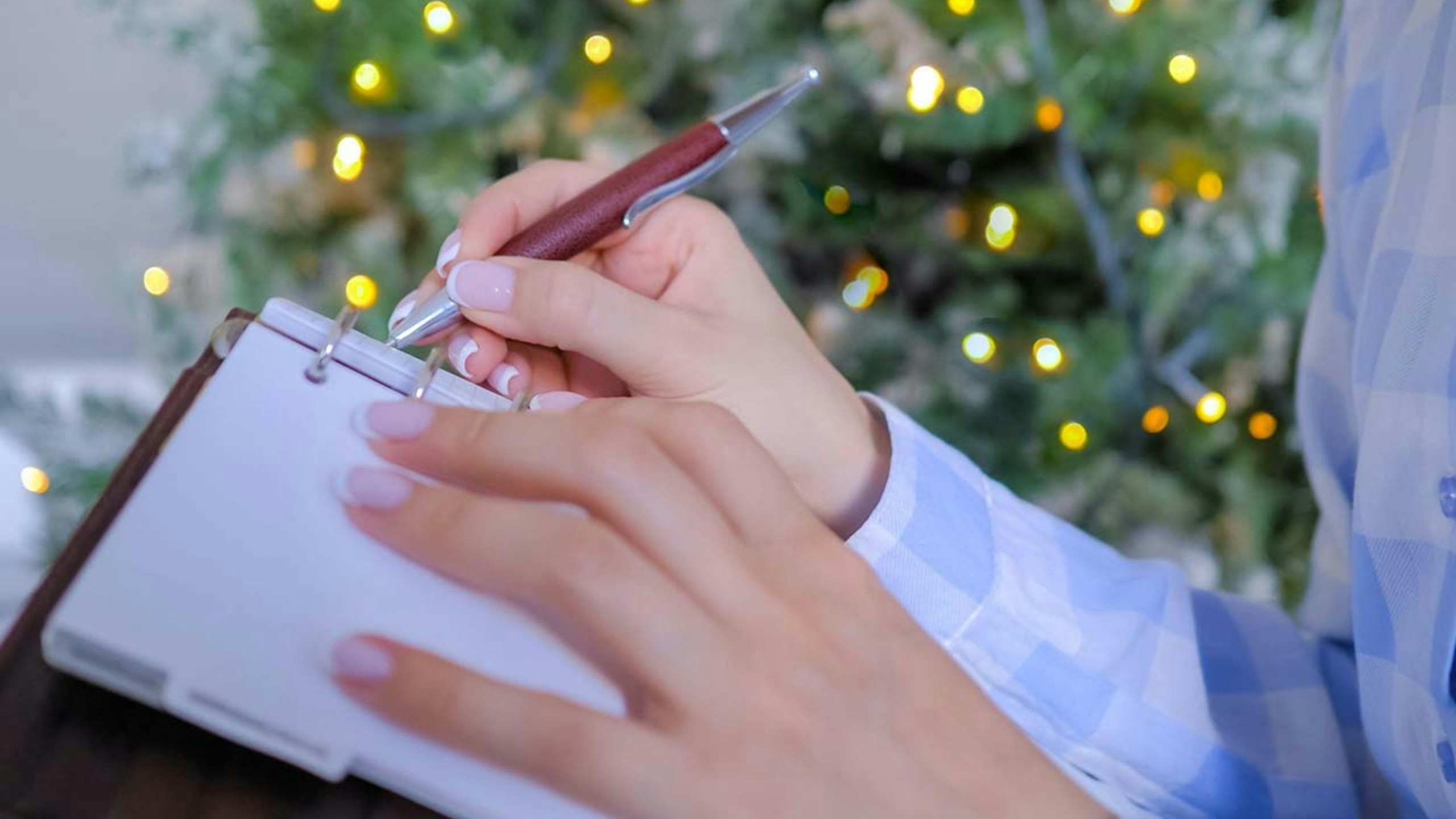 Woman writing to do list in vintage notebook organizer