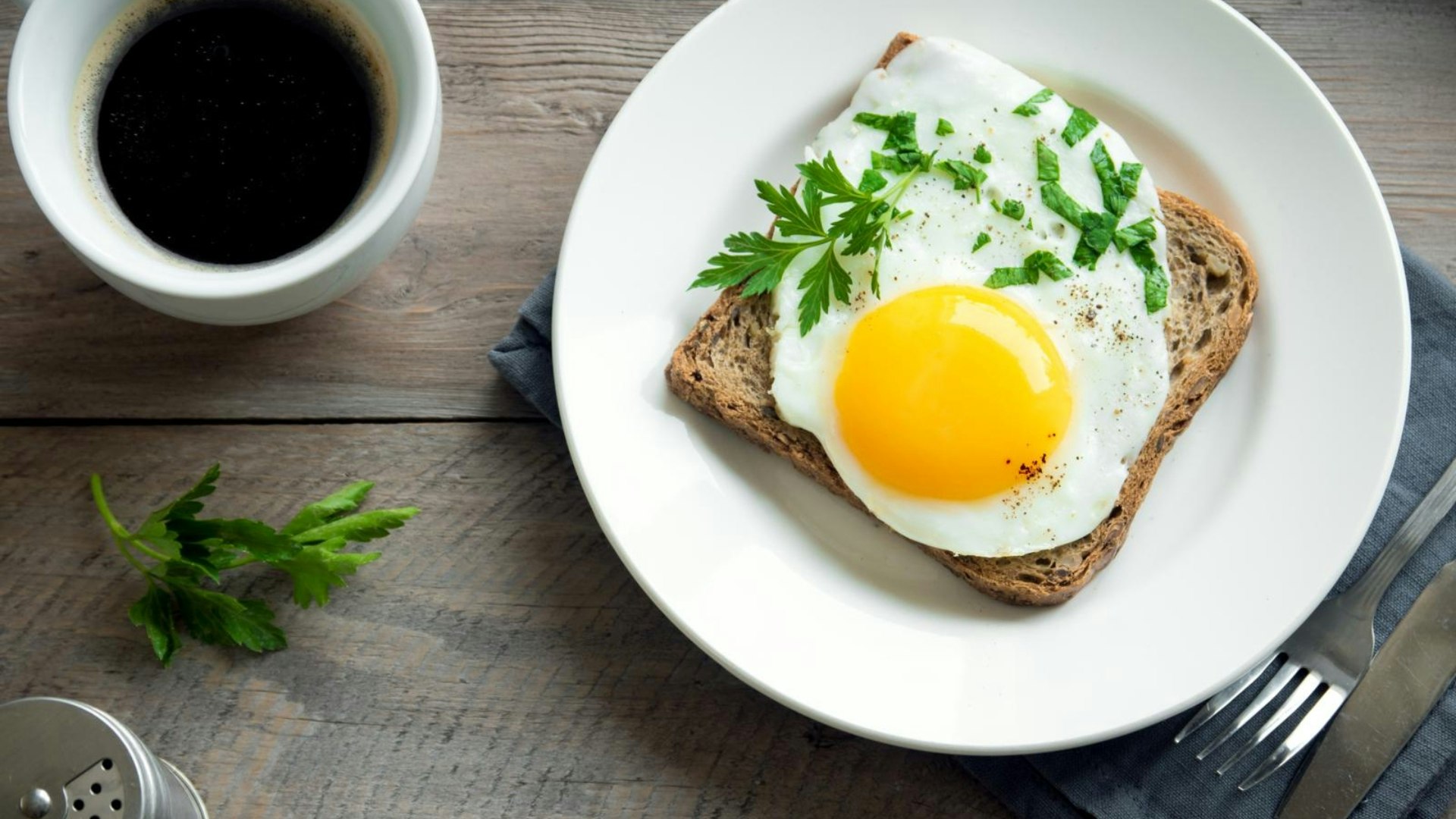 Fried Egg on Wholegrain Toast and cup of Coffee for Breakfast