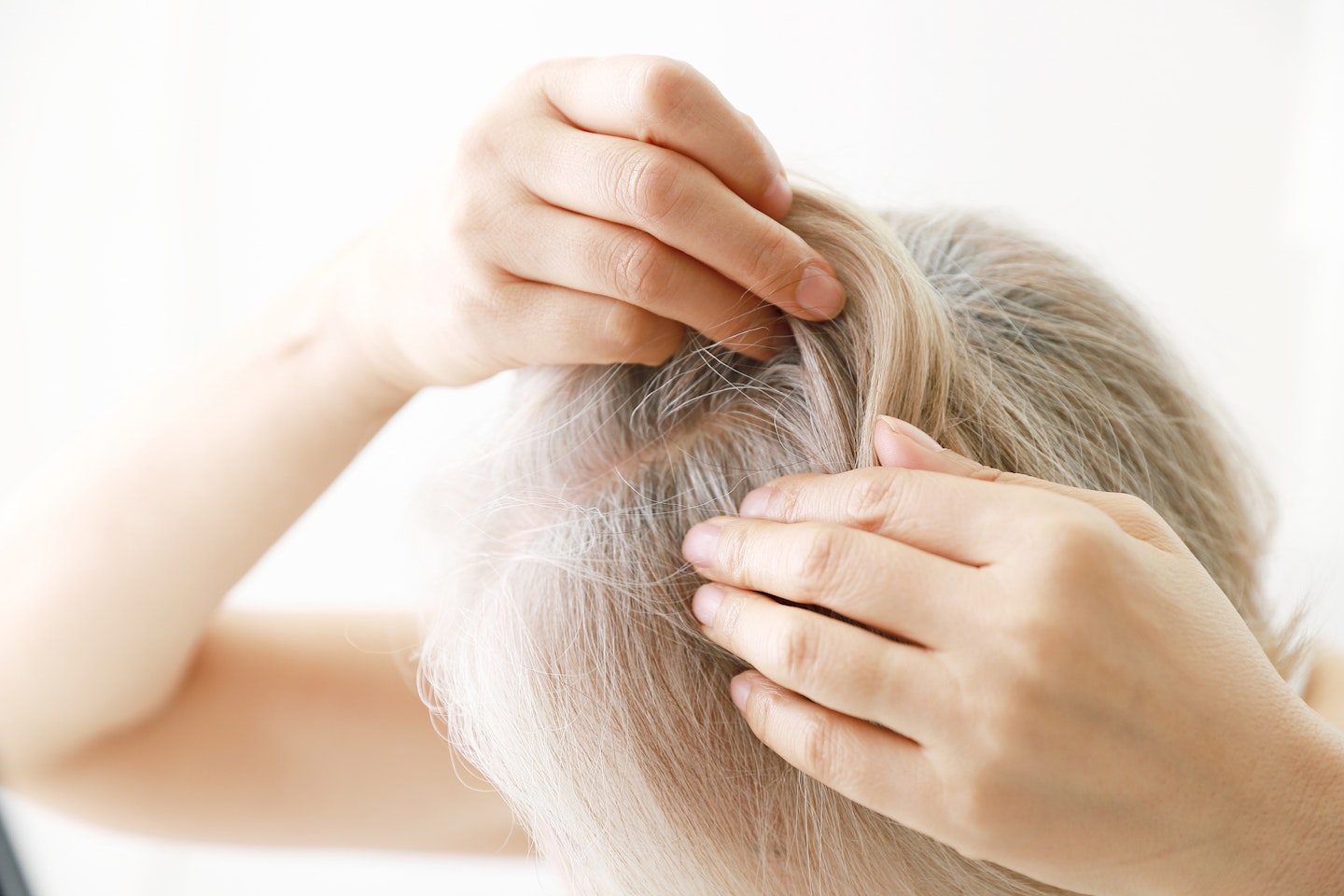 Close up of a senior woman checking her scalp