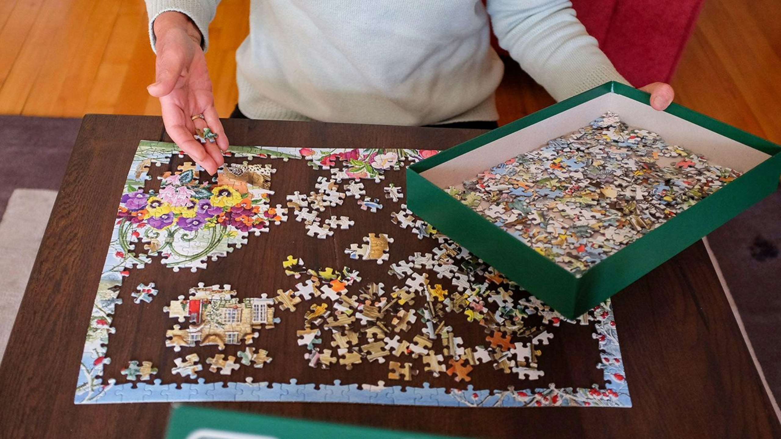 Woman at home doing a jigsaw puzzle