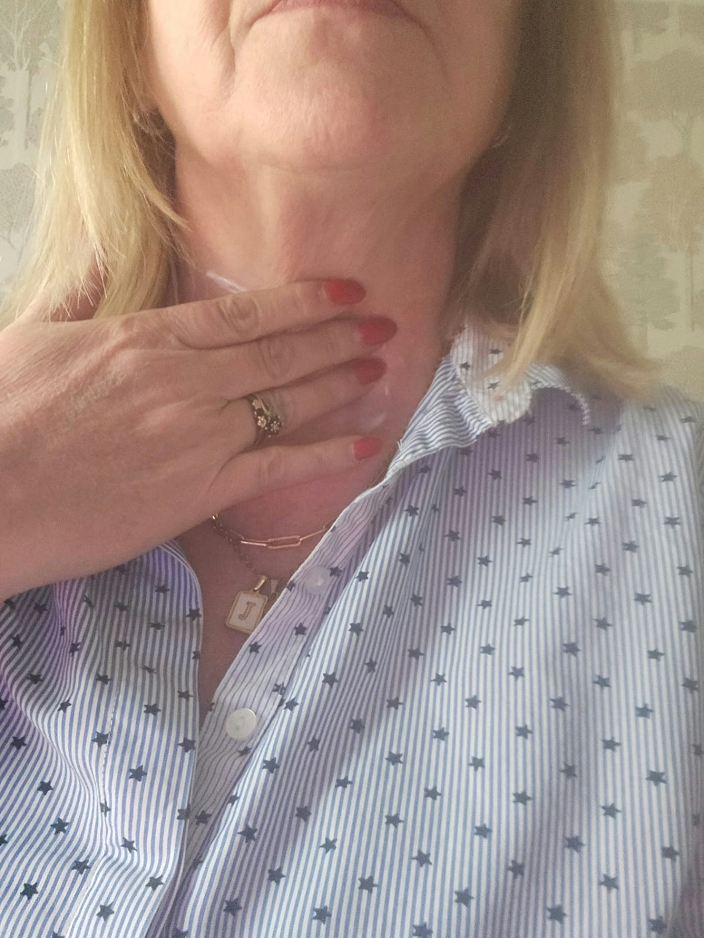 Tester using the L'OCCITANE Shea Immortelle Neck Cream