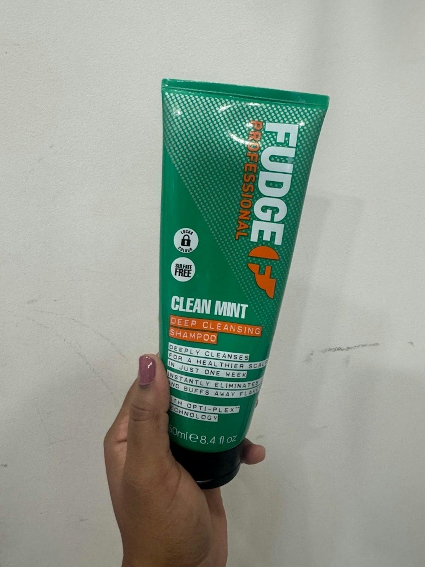 Image of tester holding the Fudge Clean Mint Shampoo