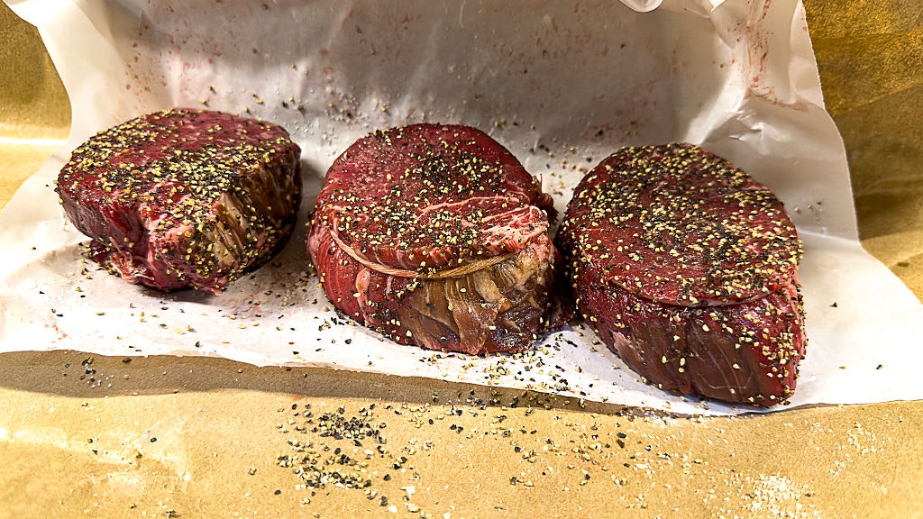 three raw steaks