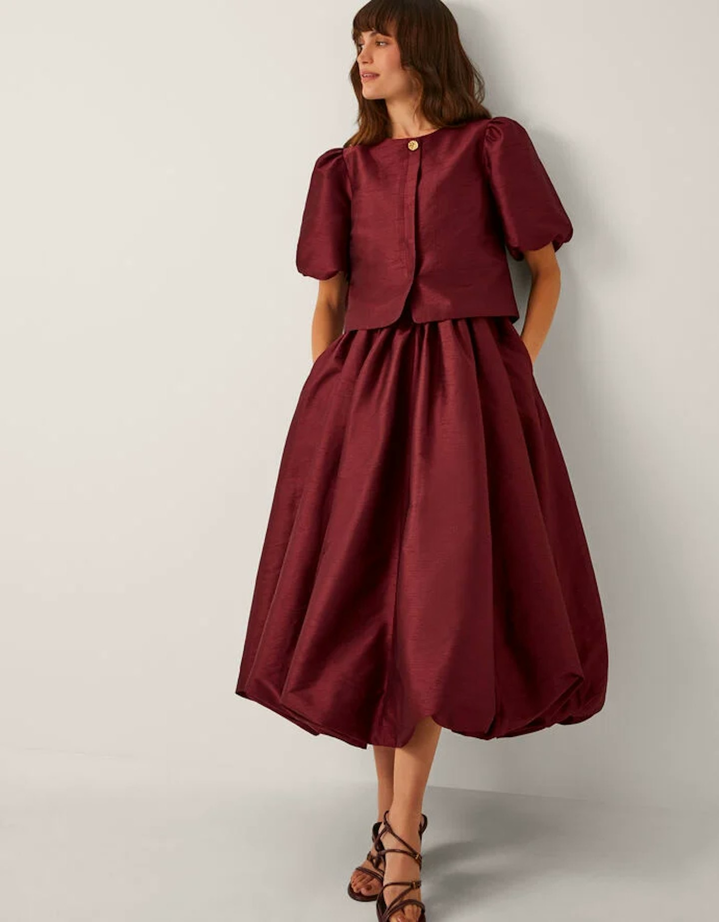 Woman wearing burgundy monsoon dress