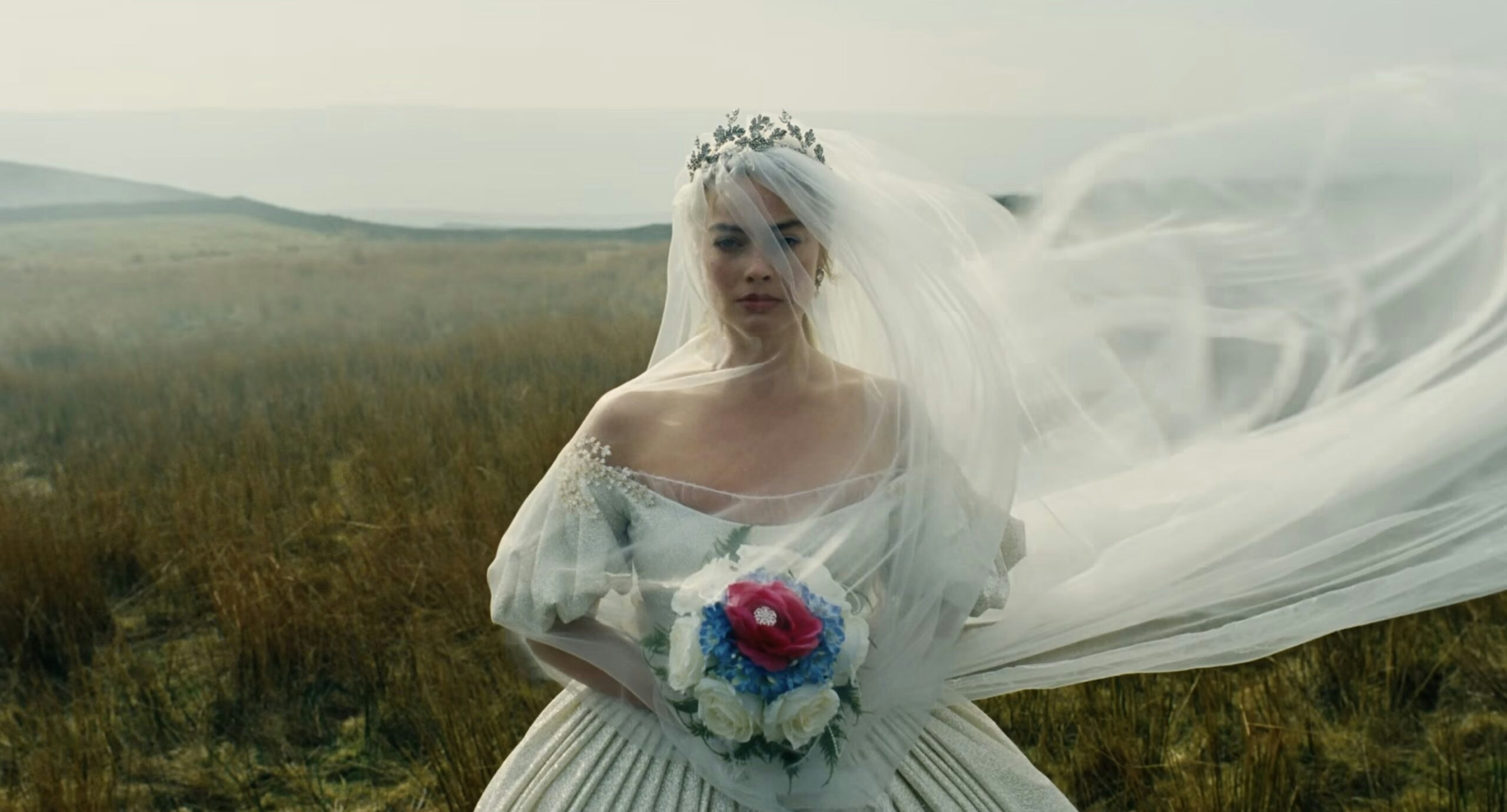 A still of Margot Robbie as Catherine Earnshaw in her wedding dress from the teaser of the film "Wuthering Heights"